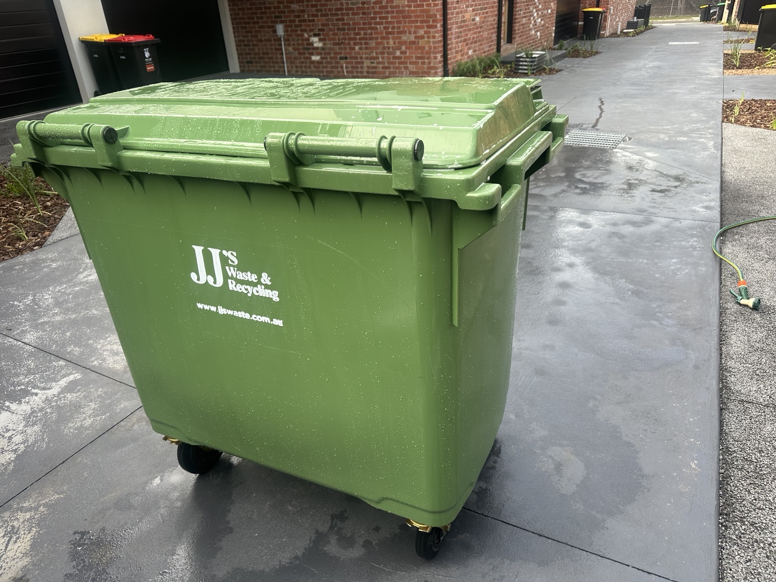 Freshly washed green commercial bin